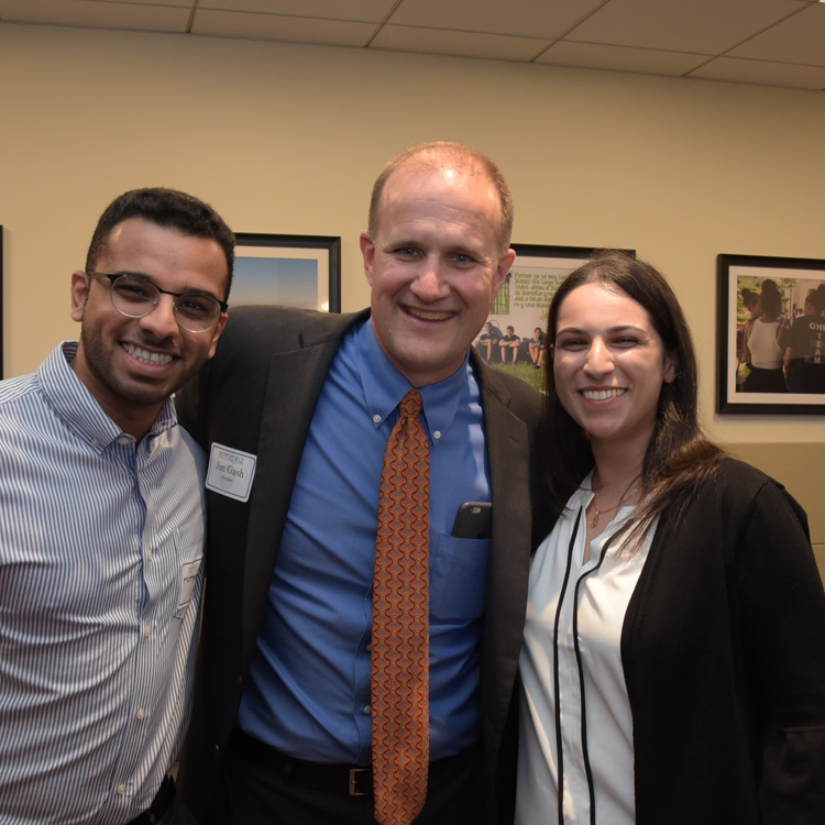 Jim Gash smiles with staff members