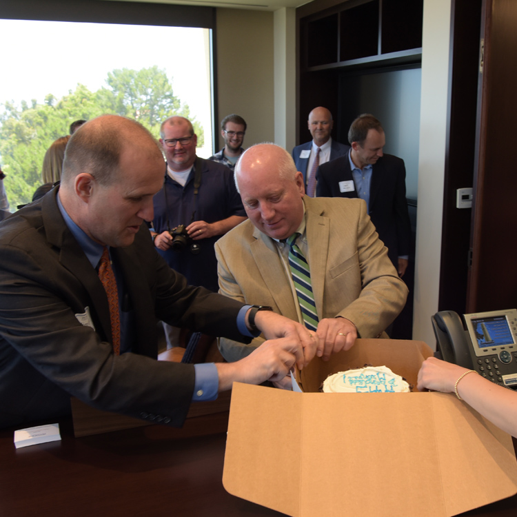 Jim Gash opens a gift with Michael Feltner