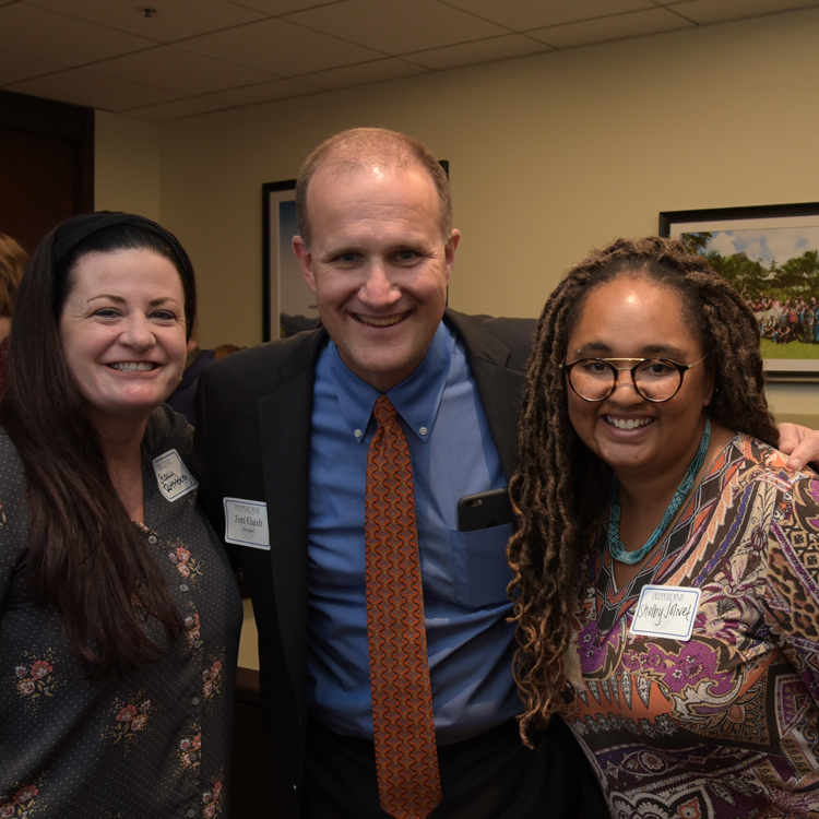 Jim Gash smiles with staff members