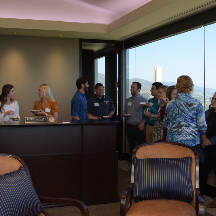 Staff members mingle in the president's suite