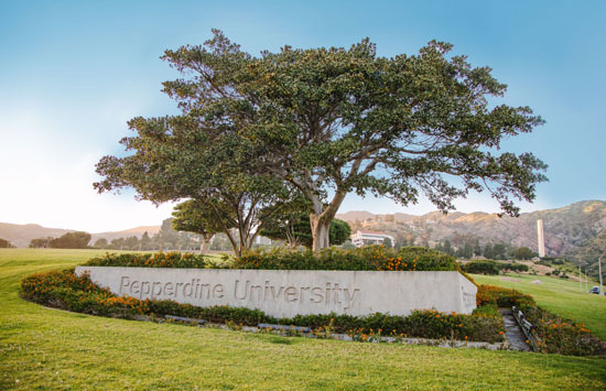 Pepperdine University concrete monument sign with a large tree in the background