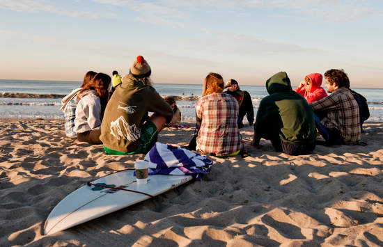 Students pray at the beach - Pepperdine University