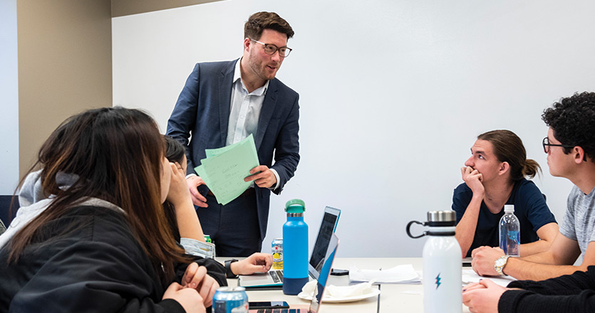 Students looking at a professor during a lecture inside a classroom