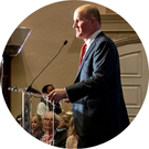 president jim gash speaking at a podium