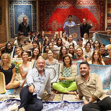 rug activity with students holding Persian and Ottoman rugs