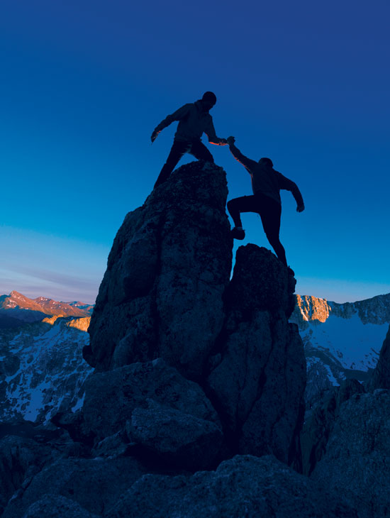 hikers climbing a peak