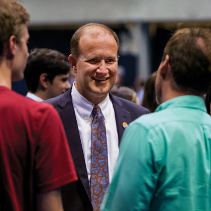 President Jim Gash meets with community members at an event.