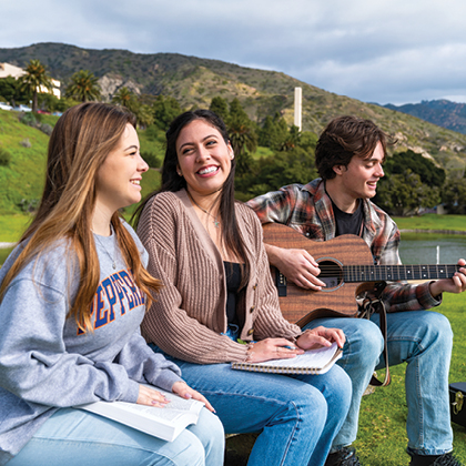 Students Listening to a student playing Guitar