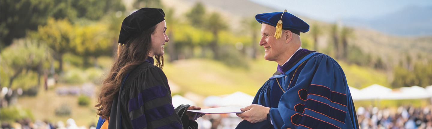 President Jim Gash handing a diploma