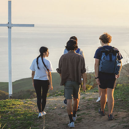 Student hiking seeing the oceanview and Pepperdine cross