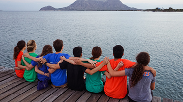 Students sitting on a pier