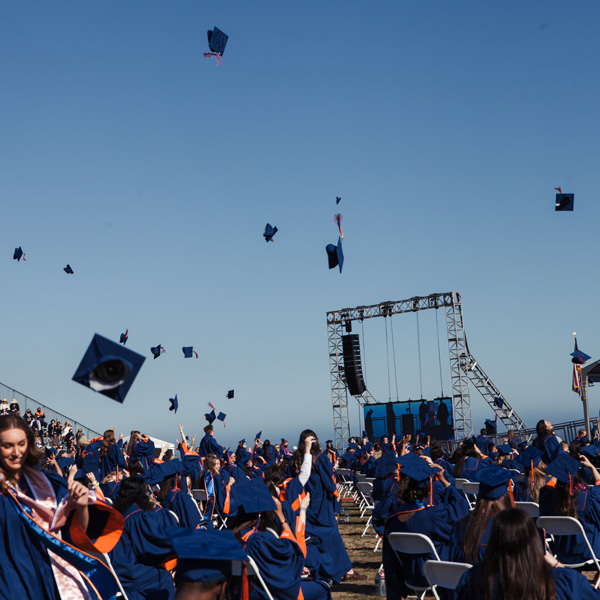 Graduations throwing caps in the air