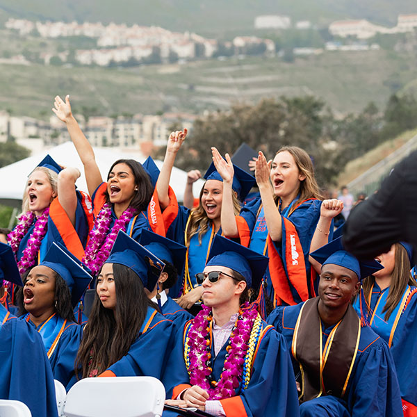 Graduates cheering in the crowd