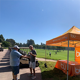 people under tents at golf outing