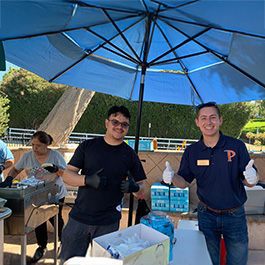 people under umbrella at a festival