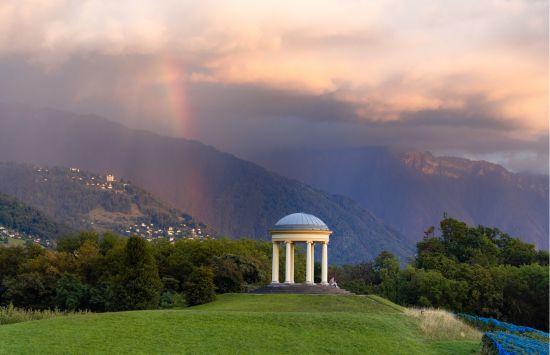 gazebo on hill with rainbow behind