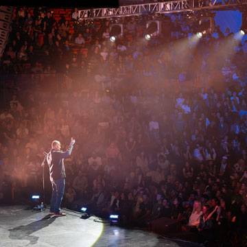 President Jim Gash on stage interacting with the crowd