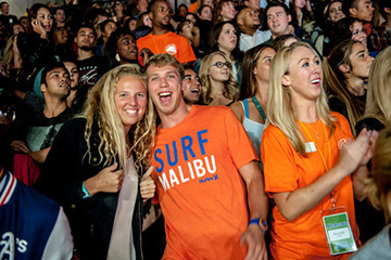 Seaver alumni in orange shirts attend a special event - Pepperdine University