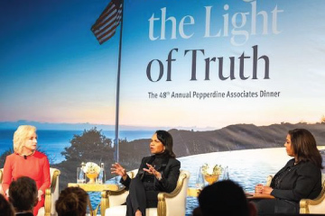 Condoleezza Rice talking on stage with panelists