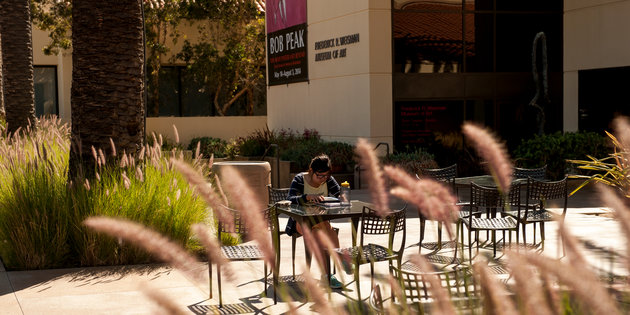 Student studying in front of the Weisman Museum - Pepperdine University