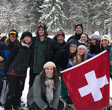 students in the snow with the Switzerland flag