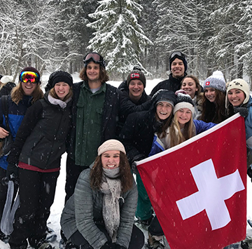 students in the snow with the Switzerland flag