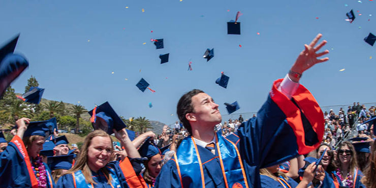 students throwing their caps at graduation