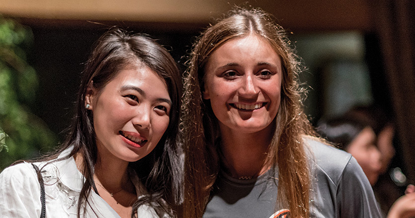 Two international students smiling together