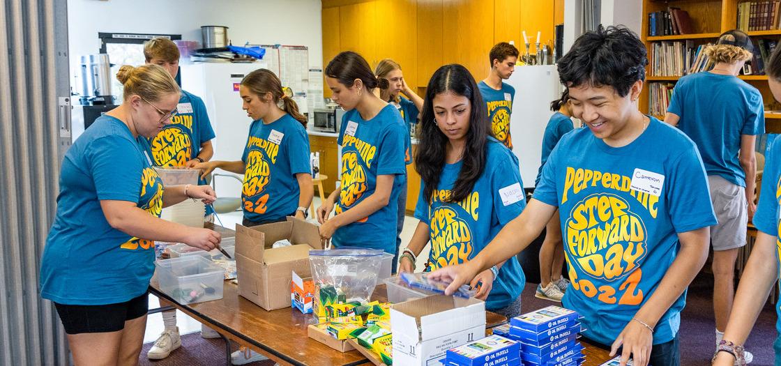 Community Engagement and Service Volunteers assembling back-to-school kits.