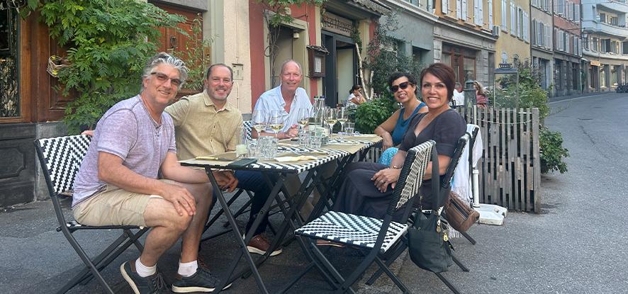 Group of adults sharing a meal at a local cafe