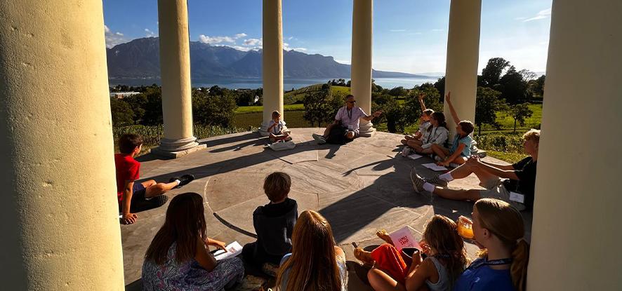 Kids taking devotional time in the cornell pavilion