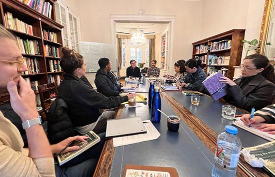 faculty around a table at a seminar