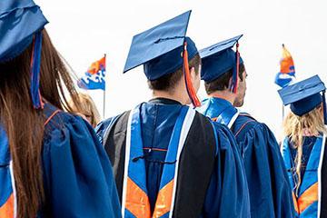 Pepperdine graduates standing in line with caps and gowns