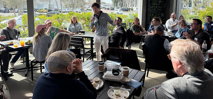 Tanner Gardner speaking to a crowd at Howdy's Cafe