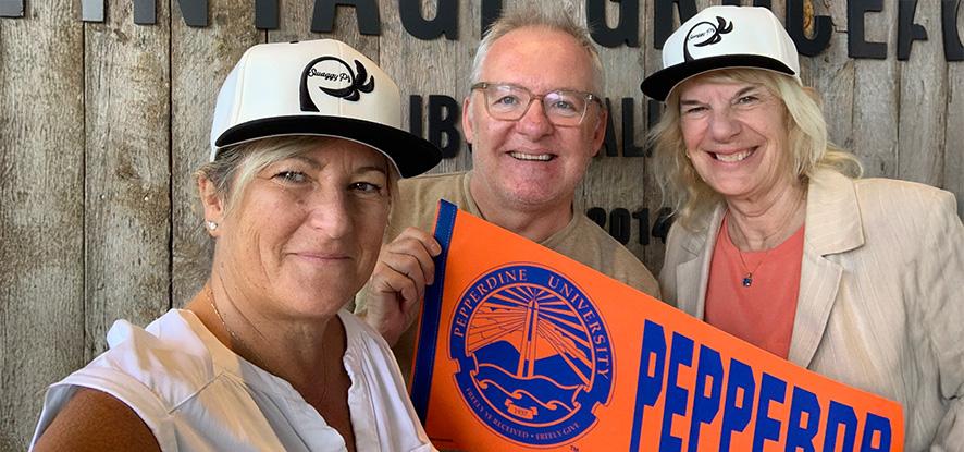 people holding Pepperidne banner at Vintage Grocers