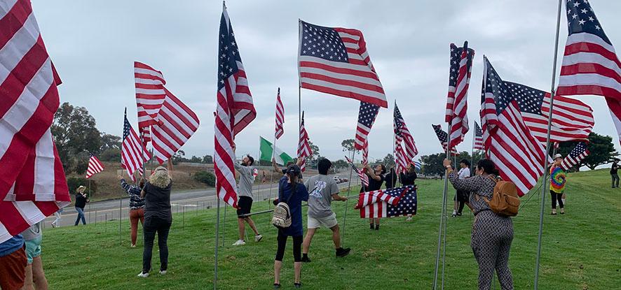 people installing flags in the ground