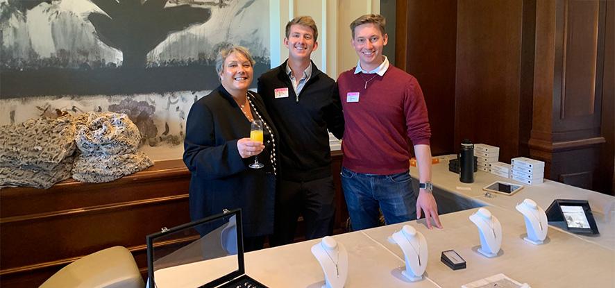 attendees at an event table with display items