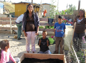 Irene with her children in their vegetable garden - Pepperdine Magazine