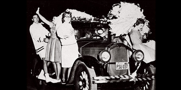 George Pepperdine College cheerleaders ride on an antique car during the 1960 homecoming celebration.