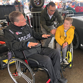 Sam Schmidt mentors a young boy in a wheelchair