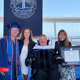Sam Schmidt receiving an honorary doctorate at his son Spencer's Seaver College graduation