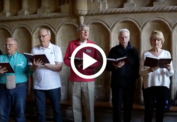 video screenshot of person holding hymnal