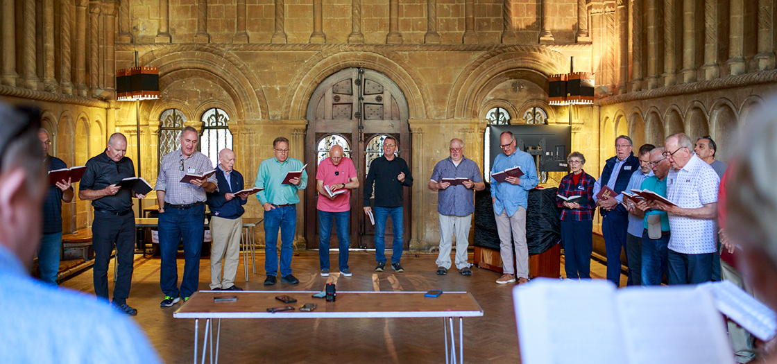 group singing together with hymnals in hands