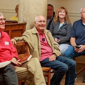 Jerry Rushford sitting in a pew with group