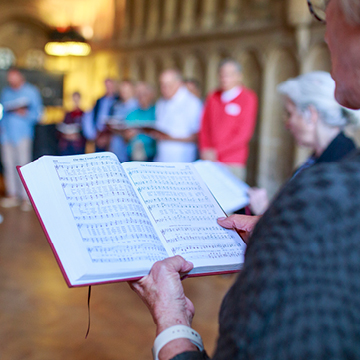 Person with hymnal book in hand