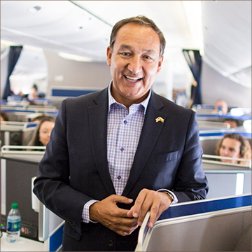 Oscar Munoz standing in an airplane