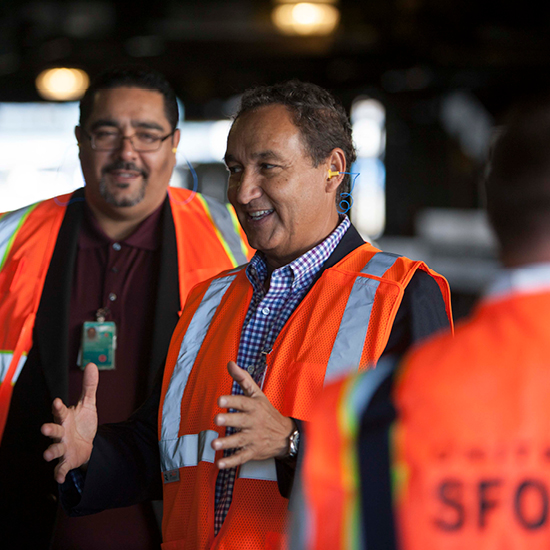 Oscar Munoz talking with flight vest on