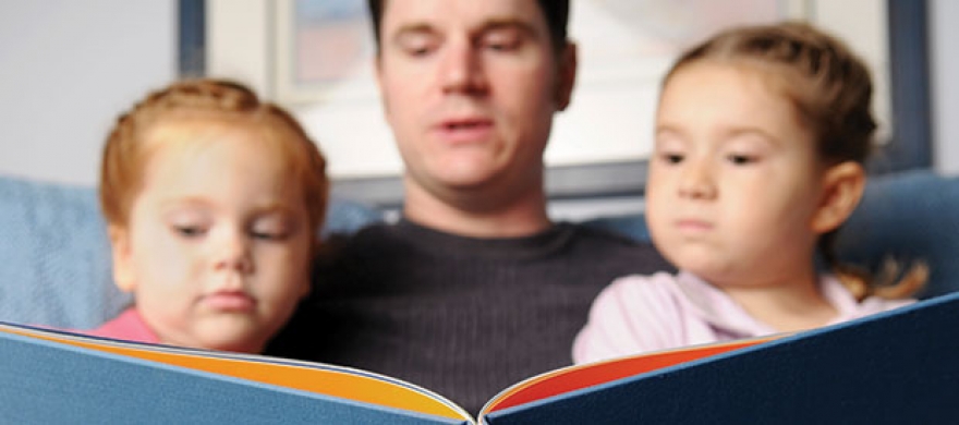 Father reading to children - Pepperdine Magazine