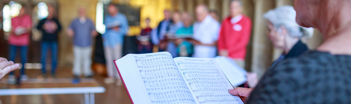 person with hymnal in hand