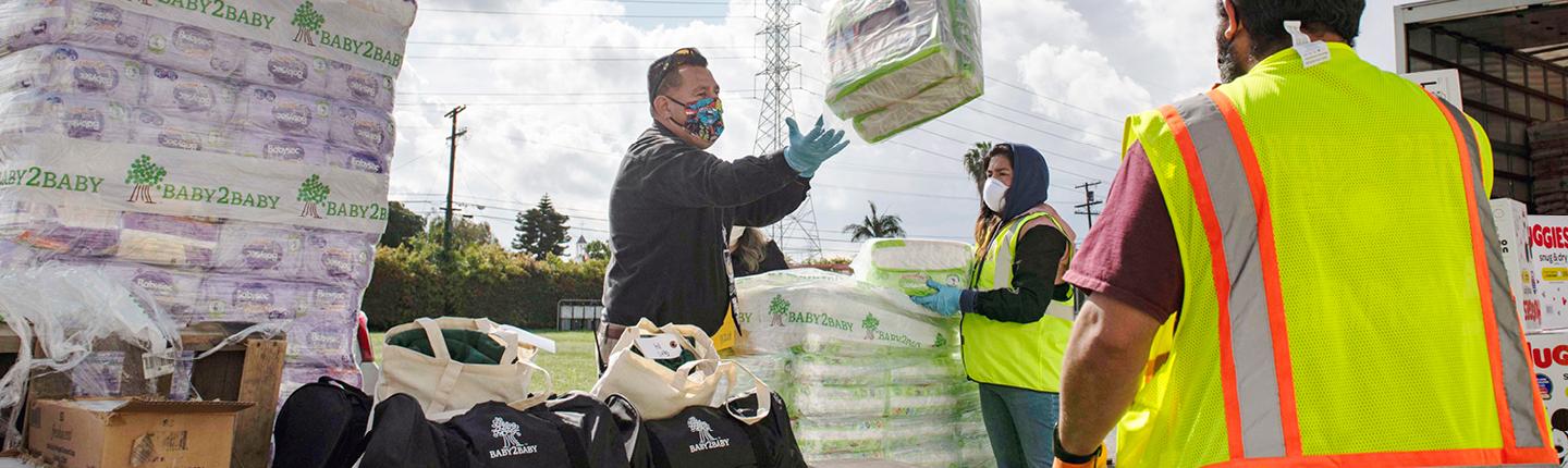 Workers unloading diapers from a delivery truck